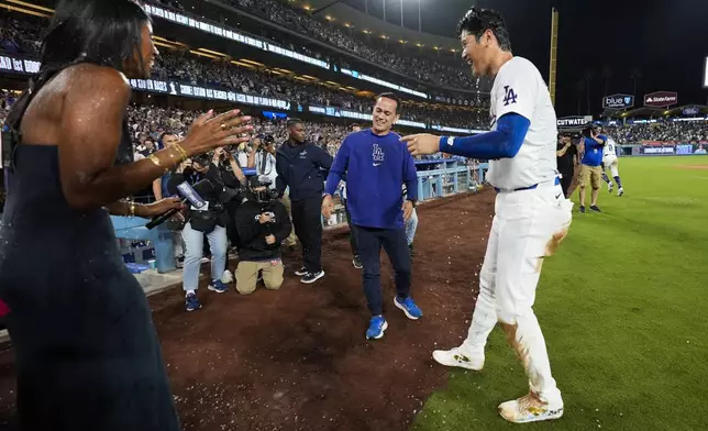 Los Angeles designated hitter Shohei Ohtani (17) reacts after teammates poured drinks on his head after hitting a grand slam during the eighth inning of a baseball game against the Tampa Bay Rays in Los Angeles, Friday, Aug. 23, 2024. Will Smith, Tommy Edman, and Max Muncy also scored. The Dodgers won 7-3. (AP Photo/Ashley Landis)