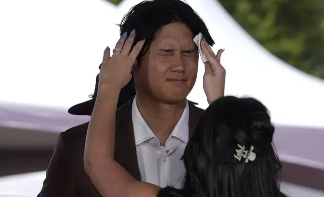 Los Angeles Dodgers' Shohei Ohtani is prepped for an interview during the baseball All-Star Game red carpet show, Tuesday, July 16, 2024, in Arlington, Texas. (AP Photo/LM Otero)