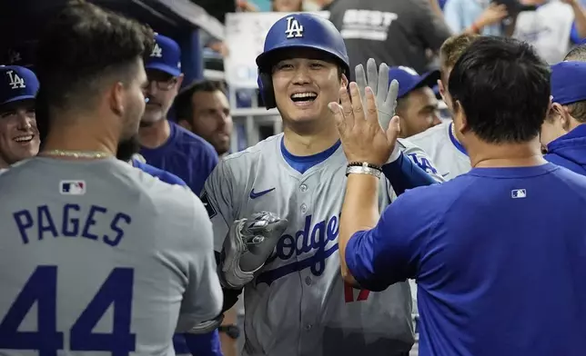 Los Angeles Dodgers' Shohei Ohtani (17) celebrates after hitting his 50th home run of the season during the seventh inning of a baseball game against the Miami Marlins, Thursday, Sept. 19, 2024, in Miami. (AP Photo/Marta Lavandier)