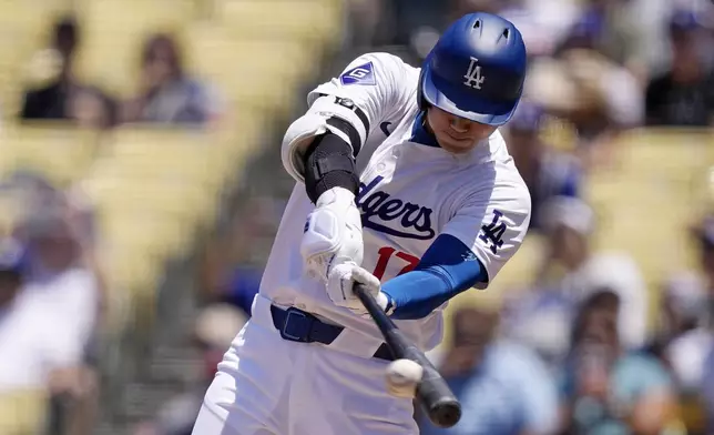 Los Angeles Dodgers' Shohei Ohtani hits a single during the third inning of a baseball game against the Milwaukee Brewers Sunday, July 7, 2024, in Los Angeles. (AP Photo/Mark J. Terrill)