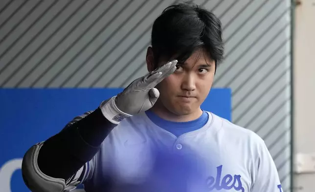 Los Angeles Dodgers' Shohei Ohtani gestures in the dugout prior to a baseball game against the Los Angeles Angels, Wednesday, Sept. 4, 2024, in Anaheim, Calif. (AP Photo/Mark J. Terrill)