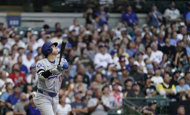 Los Angeles Dodgers' Shohei Ohtani bats during the first inning of a baseball game against the Milwaukee Brewers, Tuesday, Aug. 13, 2024, in Milwaukee. (AP Photo/Aaron Gash)