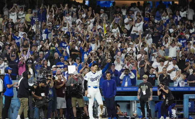 Los Angeles Dodgers designated hitter Shohei Ohtani (17) celebrates after hitting a grand slam during the ninth inning of a baseball game against the Tampa Bay Rays in Los Angeles, Friday, Aug. 23, 2024. (AP Photo/Ashley Landis)