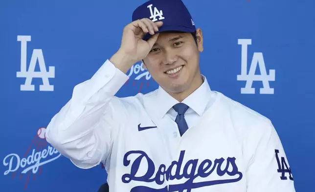 Los Angeles Dodgers' Shohei Ohtani smiles during a baseball news conference at Dodger Stadium Thursday, Dec. 14, 2023, in Los Angeles. (AP Photo/Ashley Landis)