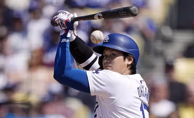 Los Angeles Dodgers' Shohei Ohtani hits a foul ball during the eighth inning of a baseball game against the Cincinnati Reds Sunday, May 19, 2024, in Los Angeles. (AP Photo/Mark J. Terrill)