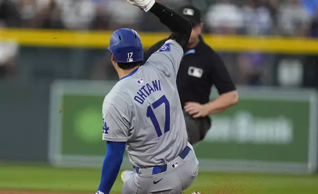 Los Angeles Dodgers' Shohei Ohtani steals second base in the second inning of a baseball game against the Colorado Rockies, Friday, Sept. 27, 2024, in Denver. (AP Photo/David Zalubowski)