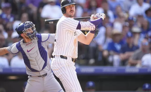 Colorado Rockies' Nolan Jones reacts after striking out against Los Angeles Dodgers relief pitcher Edgardo Henriquez in the ninth inning of a baseball game, Sunday, Sept. 29, 2024, in Denver. (AP Photo/David Zalubowski)