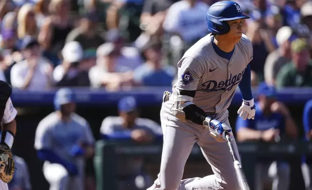 Los Angeles Dodgers' Shohei Ohtani heads up the first base line after hitting a ground ball off Colorado Rockies starting pitcher Ryan Feltner in the first inning of a baseball game Sunday, Sept. 29, 2024, in Denver. (AP Photo/David Zalubowski)