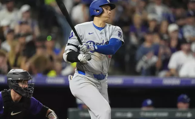 Los Angeles Dodgers' Shohei Ohtani singles off Colorado Rockies relief pitcher Anthony Molina in the fourth inning of a baseball game Friday, Sept. 27, 2024, in Denver. (AP Photo/David Zalubowski)