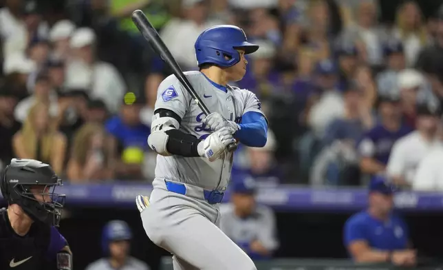 Los Angeles Dodgers' Shohei Ohtani doubles off Colorado Rockies relief pitcher Luis Peralta in the eighth inning of a baseball game, Friday, Sept. 27, 2024, in Denver. (AP Photo/David Zalubowski)