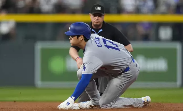 Los Angeles Dodgers' Shohei Ohtani steals second base in the second inning of a baseball game against the Colorado Rockies, Friday, Sept. 27, 2024, in Denver. (AP Photo/David Zalubowski)