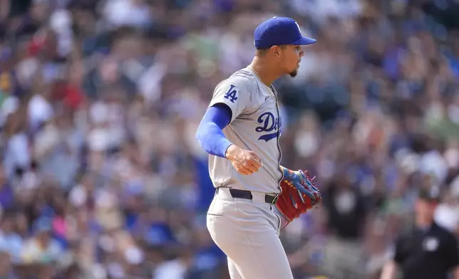 Los Angeles Dodgers relief pitcher Edgardo Henriquez reacts after retiring Colorado Rockies' Aaron Schunk to end a baseball game Sunday, Sept. 29, 2024, in Denver. (AP Photo/David Zalubowski)