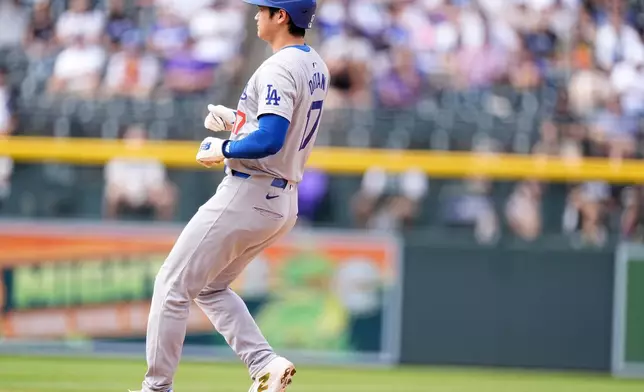 Los Angeles Dodgers' Shohei Ohtani pulls in to second base on a double steal in the eighth inning of a baseball game against the Colorado Rockies, Sunday, Sept. 29, 2024, in Denver. (AP Photo/David Zalubowski)