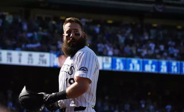 Colorado Rockies' Charlie Blackmon heads to the dugout after he was replaced by a pinch-runner following his single in his final at-bat in the third inning of a baseball game against the Los Angeles Dodgers, Sunday, Sept. 29, 2024, in Denver. (AP Photo/David Zalubowski)