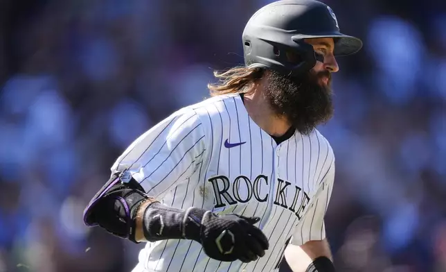 Colorado Rockies' Charlie Blackmon heads up the first base line after singling in his final at-bat off Los Angeles Dodgers relief pitcher Landon Knack in the third inning of a baseball game Sunday, Sept. 29, 2024, in Denver. (AP Photo/David Zalubowski)