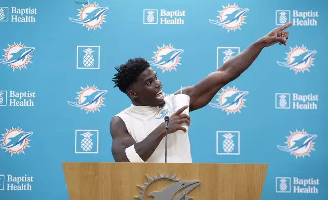 Miami Dolphins wide receiver Tyreek Hill (10) gestures as he calls for the police officer involved in his traffic stop to be fired, during a press conference following a team practice, Wednesday, Sept. 11, 2024, in Miami Gardens, Fla. (AP Photo/Rebecca Blackwell)