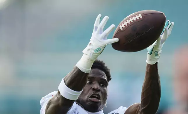 Miami Dolphins wide receiver Tyreek Hill (10) catches a pass during a team practice session, Wednesday, Sept. 11, 2024, in Miami Gardens, Fla. (AP Photo/Rebecca Blackwell)