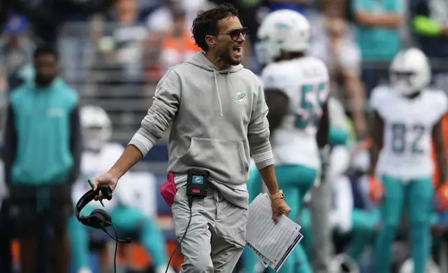 Miami Dolphins head coach Mike McDaniel reacts as Miami Dolphins quarterback Skylar Thompson is evaluated on the field after a play during the second half of an NFL football game against the Seattle Seahawks, Sunday, Sept. 22, 2024, in Seattle. (AP Photo/Lindsey Wasson)