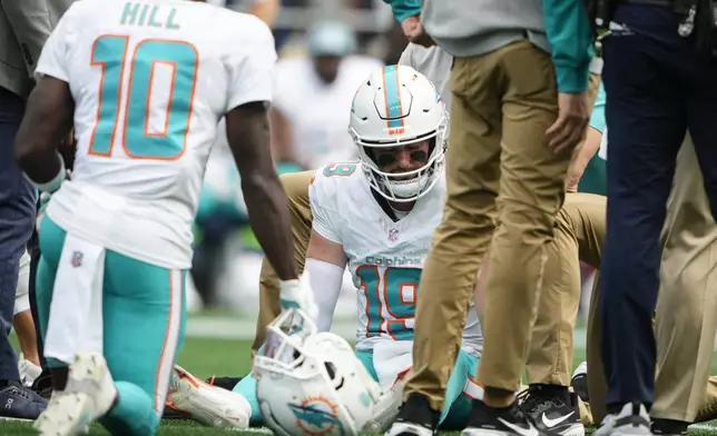 Miami Dolphins quarterback Skylar Thompson (19) is evaluated on the field after a play during the second half of an NFL football game against the Seattle Seahawks, Sunday, Sept. 22, 2024, in Seattle. (AP Photo/Lindsey Wasson)