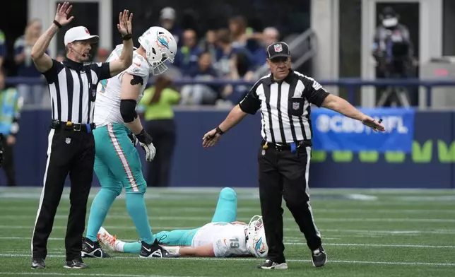 Miami Dolphins quarterback Skylar Thompson lies on the field after a play during the second half of an NFL football game against the Seattle Seahawks, Sunday, Sept. 22, 2024, in Seattle. (AP Photo/Stephen Brashear)