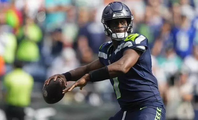 Seattle Seahawks quarterback Geno Smith looks to throw during the first half of an NFL football game against the Miami Dolphins, Sunday, Sept. 22, 2024, in Seattle. (AP Photo/Lindsey Wasson)