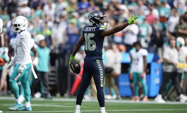 Seattle Seahawks wide receiver Tyler Lockett (16) reacts after a reception during the first half of an NFL football game against the Miami Dolphins, Sunday, Sept. 22, 2024, in Seattle. (AP Photo/Lindsey Wasson)