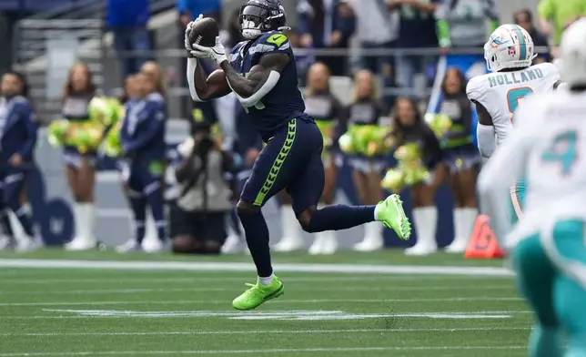 Seattle Seahawks wide receiver DK Metcalf makes a catch before running the ball for a touchdown during the first half of an NFL football game against the Miami Dolphins, Sunday, Sept. 22, 2024, in Seattle. (AP Photo/Stephen Brashear)