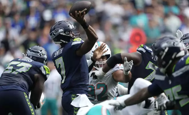 Seattle Seahawks quarterback Geno Smith (7) throws a touchdown pass to Seattle Seahawks wide receiver DK Metcalf, not pictured, during the first half of an NFL football game Sunday, Sept. 22, 2024, in Seattle. (AP Photo/Lindsey Wasson)