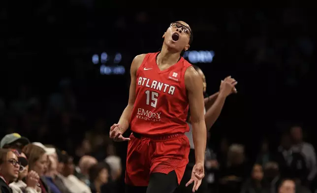 Atlanta Dream guard Allisha Gray reacts after making a 3-point basket during the first half of a first-round WNBA basketball playoff game against the New York Liberty, Tuesday, Sept. 24, 2024, in New York. (AP Photo/Adam Hunger)