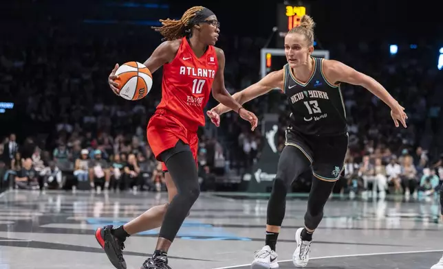 Atlanta Dream guard Rhyne Howard (10) is defended by New York Liberty forward Leonie Fiebich (13) during the second half of a WNBA basketball first-round playoff game Sunday, Sept. 22, 2024, in New York. (AP Photo/Corey Sipkin)