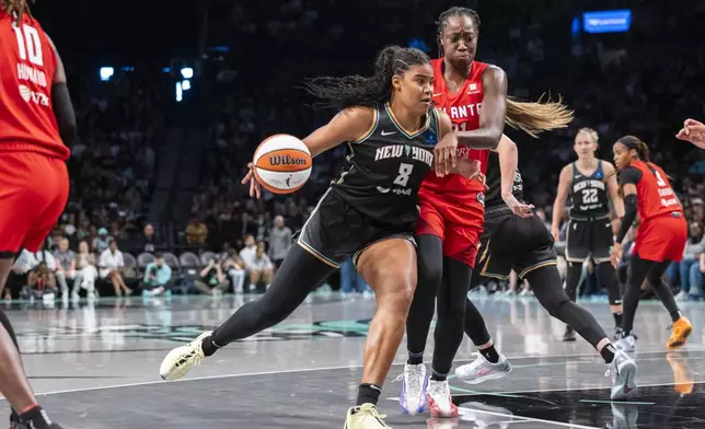 New York Liberty forward Nyara Sabally (8) is defended by Atlanta Dream center Tina Charles (31) during the first half of a WNBA first round game 1 playoff basketball game, Sunday, Sept. 22, 2024, in New York. (AP Photo/Corey Sipkin)