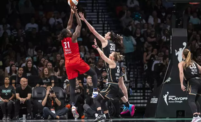 New York Liberty forward Breanna Stewart (30) defends Atlanta Dream center Tina Charles (31) during the first half of a WNBA basketball first-round playoff game Sunday, Sept. 22, 2024, in New York. (AP Photo/Corey Sipkin)