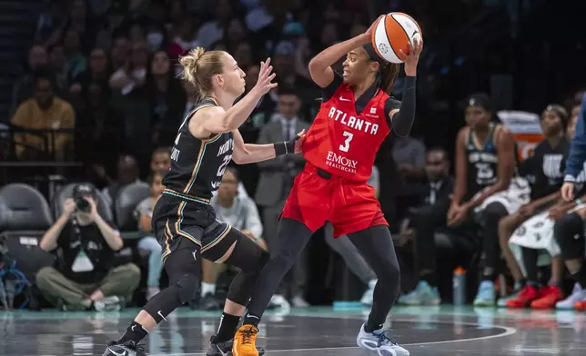 Atlanta Dream guard Jordin Canada (3) is defended by New York Liberty guard Courtney Vandersloot (22) during the first half of a WNBA first round game 1 playoff basketball game, Sunday, Sept. 22, 2024, in New York. (AP Photo/Corey Sipkin)