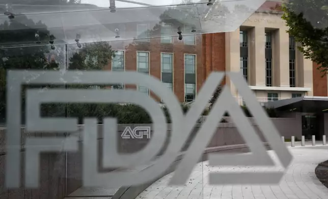 FILE - A U.S. Food and Drug Administration building is seen behind FDA logos at a bus stop on the agency's campus in Silver Spring, Md., on Aug. 2, 2018. (AP Photo/Jacquelyn Martin, File)