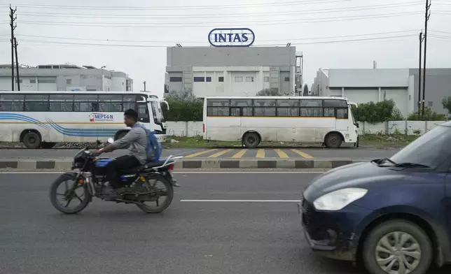 Commuters drive past the INTAS pharmaceutical manufacturing plant in Ahmedabad, India, Friday, Aug. 2, 2024, which had produced tainted eyedrops which sickened more than 80 Americans, killing four of them and blinding more than a dozen others. (AP Photo/Ajit Solanki)