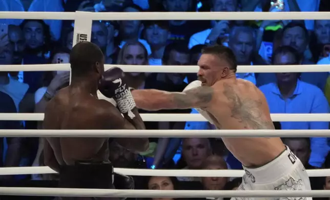 FILE - Ukraine's Oleksandr Usyk, right, lands a blow on Britain's Daniel Dubois during their world heavyweight title fight at Tarczynski Arena in Wroclaw, Poland, Sunday, Aug. 27, 2023. (AP Photo/Czarek Sokolowski, file)