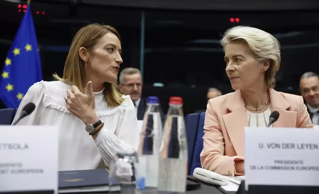 European Parliament President Roberta Metsola, left, and European Commission President Ursula von der Leyen, right, talk prior to the start of a session at the European Parliament, Tuesday, Sept. 17, 2024 in Strasbourg. (AP Photo/Jean-Francois Badias)