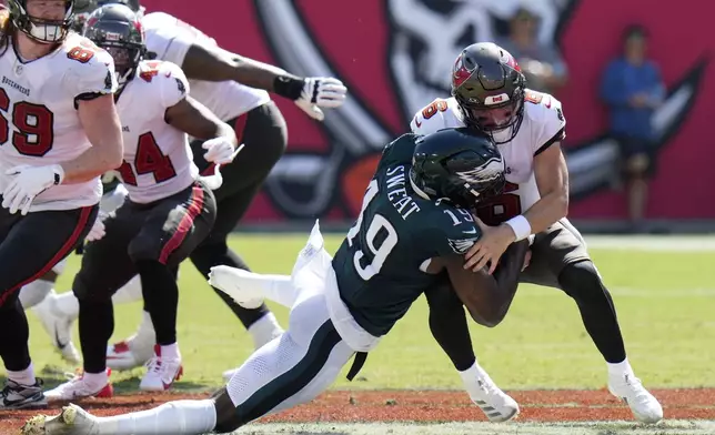 Tampa Bay Buccaneers' Baker Mayfield, right, is sacked by Philadelphia Eagles' Josh Sweat during the second half of an NFL football game, Sunday, Sept. 29, 2024, in Tampa, Fla. (AP Photo/Chris O'Meara)