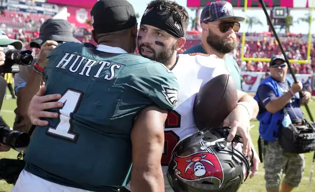 Tampa Bay Buccaneers' Baker Mayfield, right, and Philadelphia Eagles' Jalen Hurts meet after an NFL football game, Sunday, Sept. 29, 2024, in Tampa, Fla. (AP Photo/Chris O'Meara)