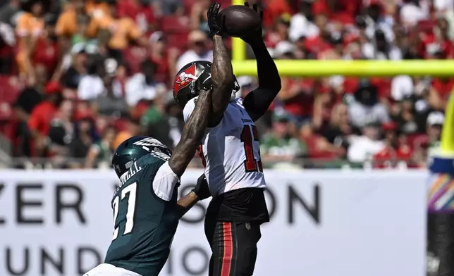 Tampa Bay Buccaneers' Sterling Shepard, right, catches a pass against Philadelphia Eagles' Quinyon Mitchell during the second half of an NFL football game, Sunday, Sept. 29, 2024, in Tampa, Fla. (AP Photo/Jason Behnken)