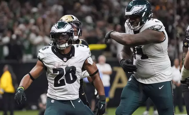 Philadelphia Eagles running back Saquon Barkley (26) celebrates after scoring a two-point conversion against the New Orleans Saints in the second half of an NFL football game in New Orleans, Sunday, Sept. 22, 2024. (AP Photo/Gerald Herbert)