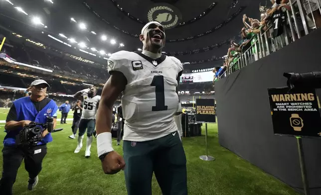 Philadelphia Eagles quarterback Jalen Hurts (1) leaves the field after a win over the New Orleans Saints in an NFL football game in New Orleans, Sunday, Sept. 22, 2024. (AP Photo/Gerald Herbert)