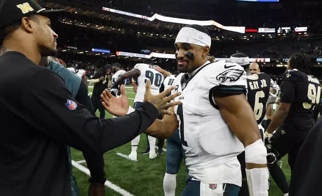 Philadelphia Eagles quarterback Jalen Hurts (1) is congratulated after a win over the New Orleans Saints in an NFL football game in New Orleans, Sunday, Sept. 22, 2024. (AP Photo/Butch Dill)