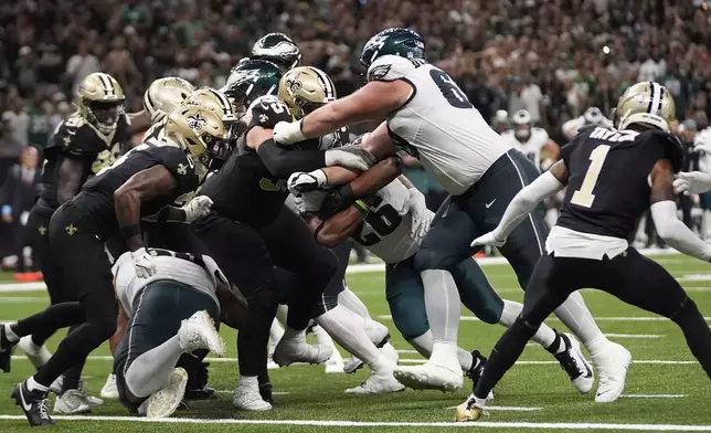 Philadelphia Eagles running back Saquon Barkley (26) scores the winning touchdown against the New Orleans Saints in the second half of an NFL football game in New Orleans, Sunday, Sept. 22, 2024. (AP Photo/Gerald Herbert)