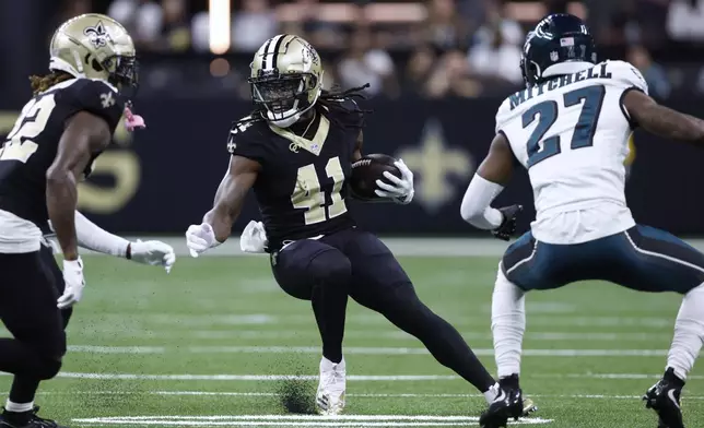 New Orleans Saints running back Alvin Kamara (41) runs the ball against Philadelphia Eagles cornerback Quinyon Mitchell (27) in the first half of an NFL football game in New Orleans, Sunday, Sept. 22, 2024. (AP Photo/Butch Dill)