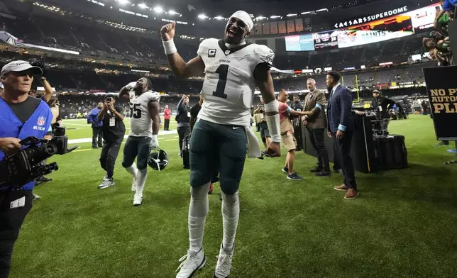 Philadelphia Eagles quarterback Jalen Hurts (1) leaves the field after a win over the New Orleans Saints in an NFL football game in New Orleans, Sunday, Sept. 22, 2024. (AP Photo/Gerald Herbert)