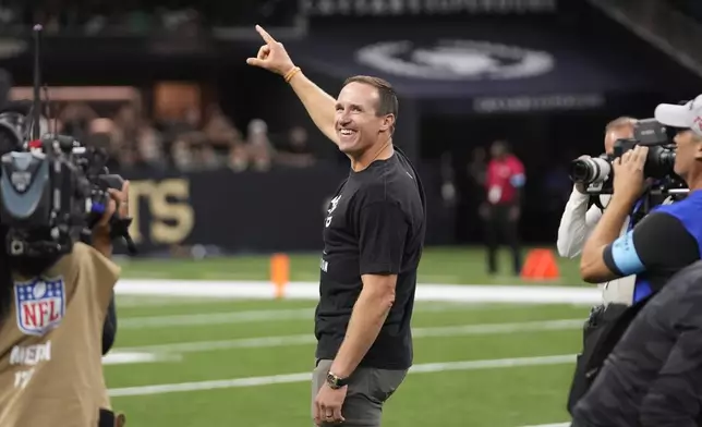 Former New Orleans Saints quarterback Drew Brees is honored during a halftime ceremony at an NFL football game between the Saints and the Philadelphia Eagles in New Orleans, Sunday, Sept. 22, 2024. (AP Photo/Gerald Herbert)