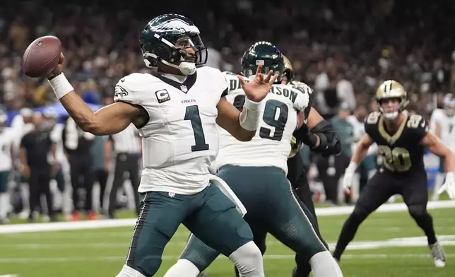 Philadelphia Eagles quarterback Jalen Hurts (1) passes against the New Orleans Saints in the first half of an NFL football game in New Orleans, Sunday, Sept. 22, 2024. (AP Photo/Gerald Herbert)