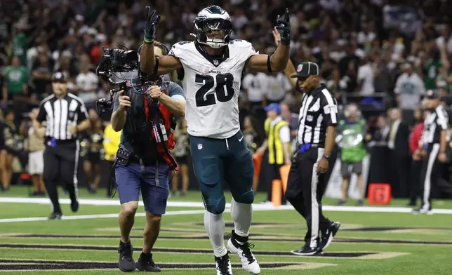 Philadelphia Eagles running back Saquon Barkley (26) celebrates after scoring a two-point conversion against the New Orleans Saints in the second half of an NFL football game in New Orleans, Sunday, Sept. 22, 2024. (AP Photo/Gerald Herbert)