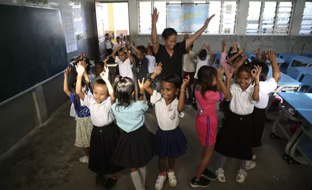 Children dance in a classroom in Dili, East Timor on Thursday, Sept. 5, 2024. (AP Photo/Firdia Lisnawati)